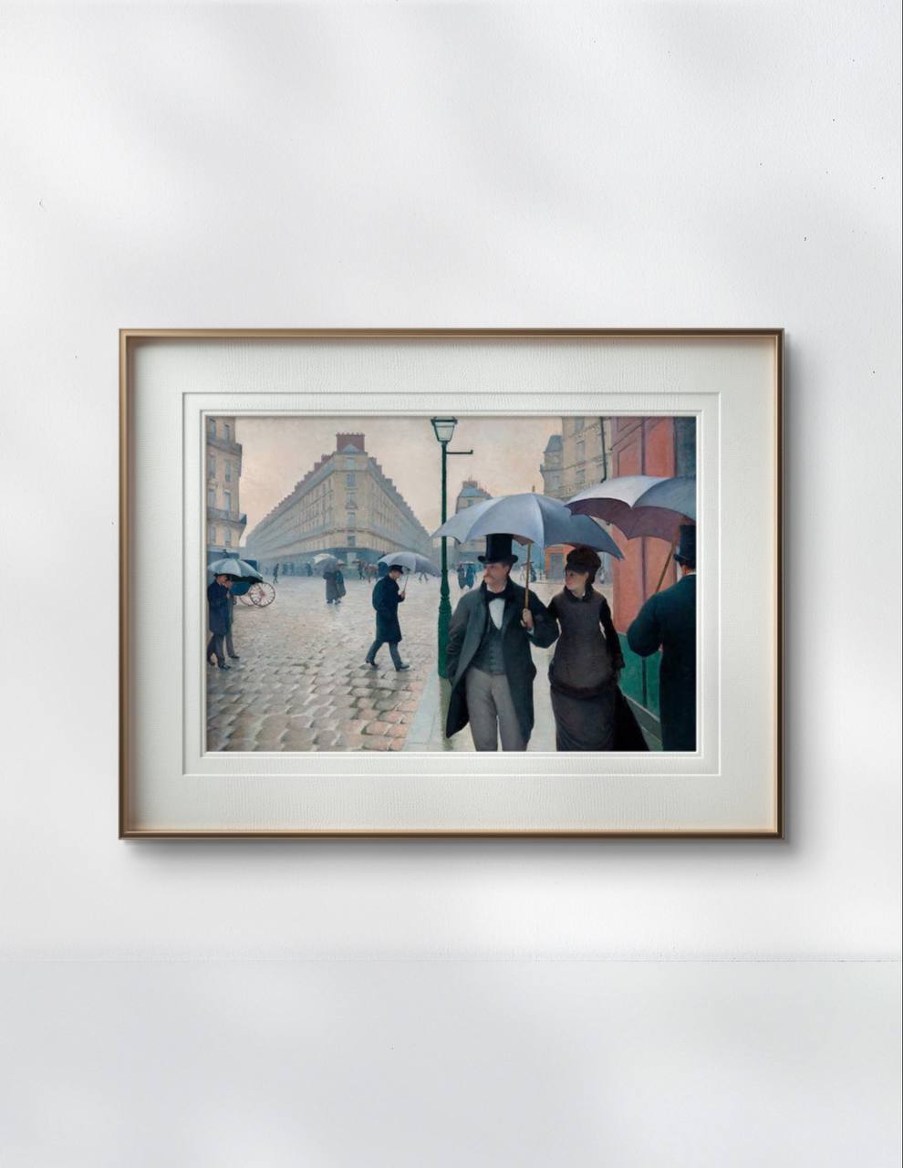 Framed artwork showing a rainy Parisian street scene with people under umbrellas. The elegant print captures the city's atmosphere, perfect for a sophisticated home decor setting.