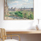 Framed artwork of a bustling Parisian square on a sunny day, with lush trees and historic architecture. The painting adds a lively and classic touch to the elegant home workspace