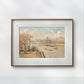 Framed artwork of the Louvre as seen from the Pont Neuf. The painting shows boats on the Seine and a view of Paris' historic architecture, adding a touch of elegance and charm to any wall