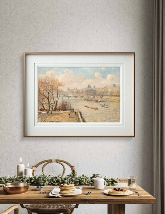 Framed painting of the Louvre from Pont Neuf, hanging in a dining room. The serene view of boats on the Seine and Parisian architecture creates a peaceful, cultured atmosphere in the space