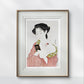 Framed print of a Japanese woman applying makeup, dressed in a soft pink kimono. The detailed and graceful illustration brings a touch of classic beauty to the modern home.