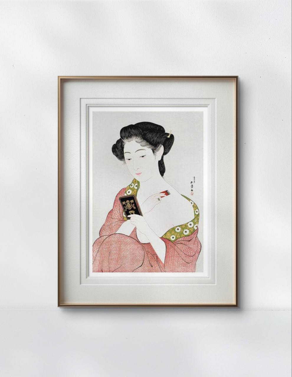 Framed print of a Japanese woman applying makeup, dressed in a soft pink kimono. The detailed and graceful illustration brings a touch of classic beauty to the modern home.