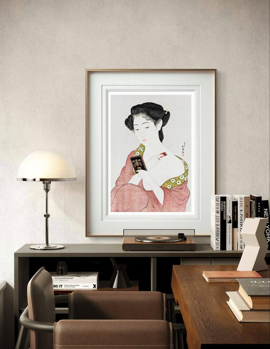 Framed artwork of a Japanese woman in a kimono applying powder, adding a sense of elegance and tranquility to the space. The soft colors and delicate design enhance the room's calm atmosphere