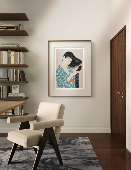 Framed artwork of a Japanese woman carefully combing her long black hair, adding a sense of elegance and tranquility to this cozy home office. The detailed kimono pattern enhances the room’s artistic atmosphere.