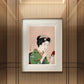 Framed print of a Japanese woman in a green kimono, applying makeup. The vibrant yet delicate illustration adds a touch of traditional elegance to this modern interior.