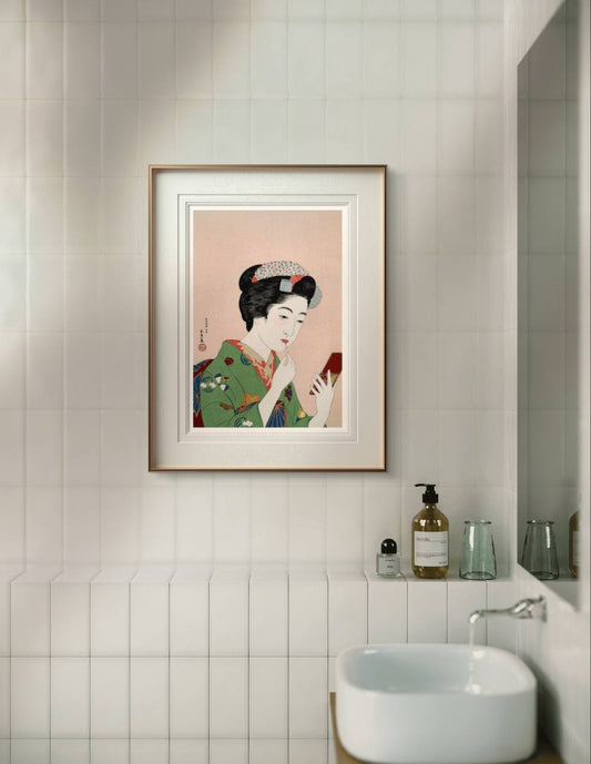 "Framed artwork of a Japanese woman gracefully applying lipstick, enhancing the tranquility of this bathroom space. The beautiful kimono design and soft color palette bring a calming atmosphere