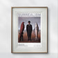 The framed poster shows a man in a suit standing between a bird and a fish. The word 'Surrealism' is at the top. The frame has a simple, elegant design, displayed on a plain wall