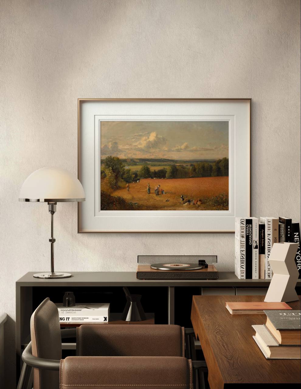 A framed painting of a wheat field with harvesters at work, set against a backdrop of rolling hills and soft clouds. The warm, earthy tones add a rustic charm to the modern room