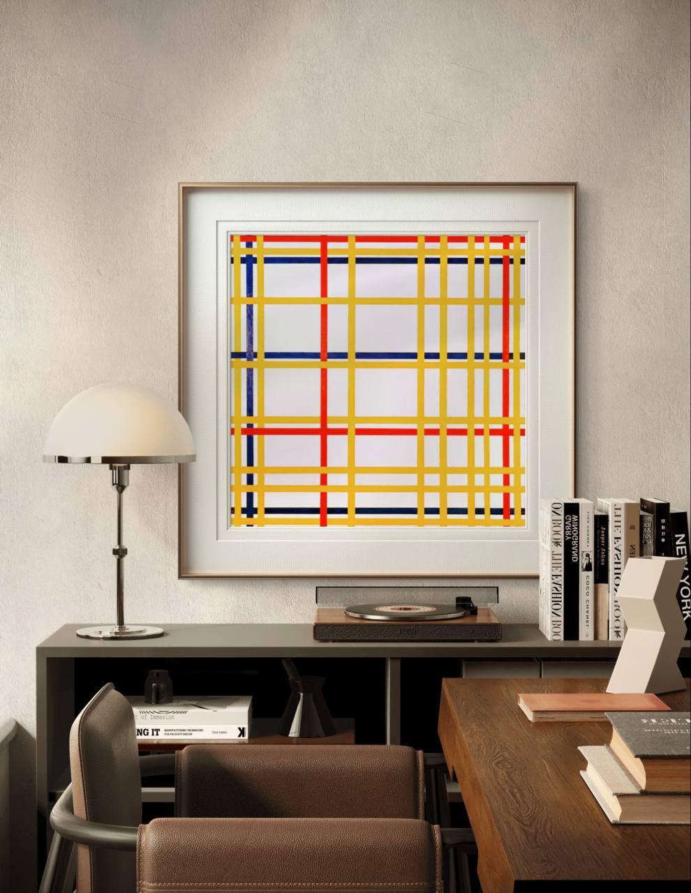 A framed abstract print with intersecting red, blue, and yellow lines. The geometric design adds a striking modern touch to the minimalist decor of the room