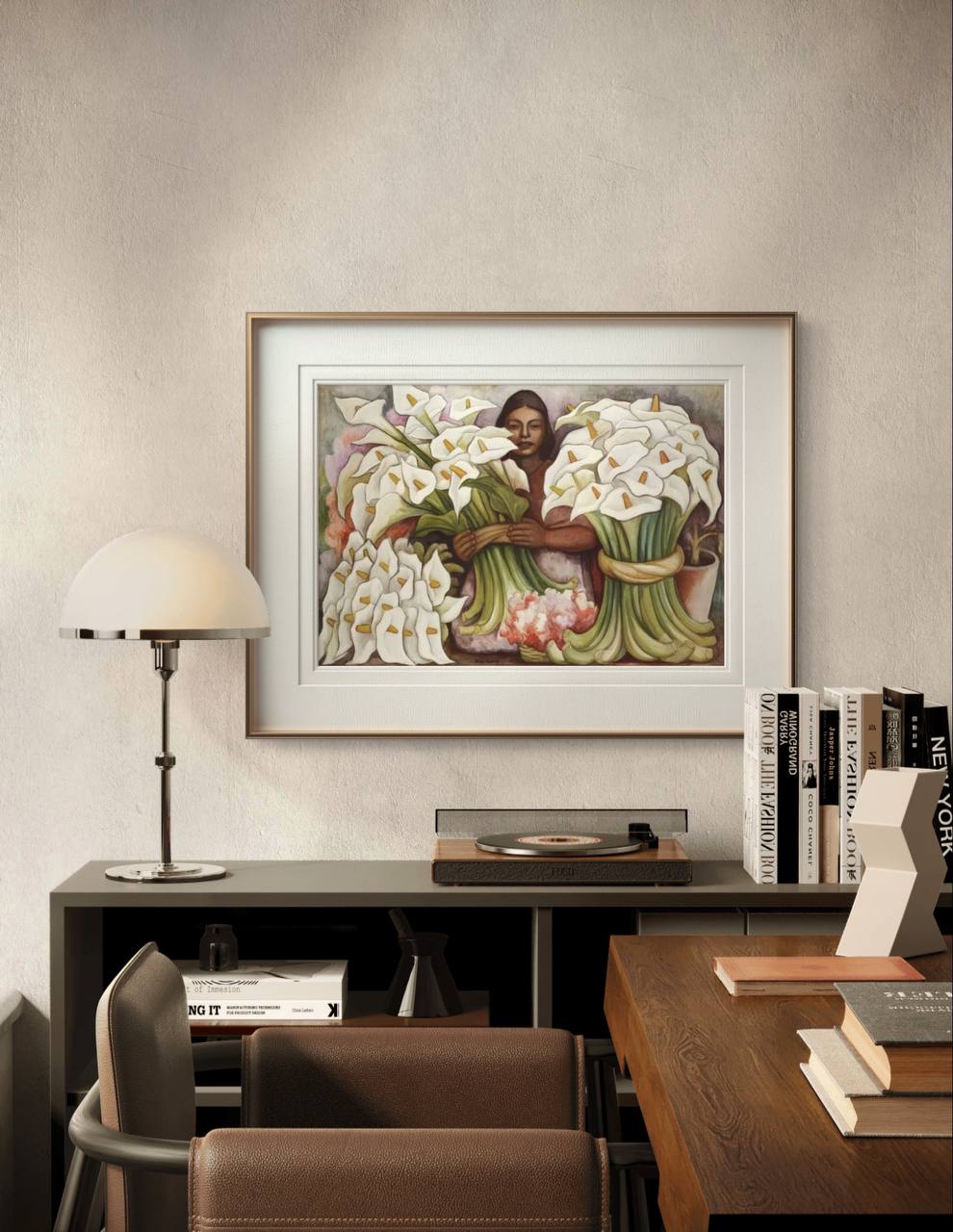 The "Vendedora de Alcatraces" painting is framed and displayed in a stylish room. A turntable, books, and soft lighting add warmth to the space, highlighting the art's rich colors.