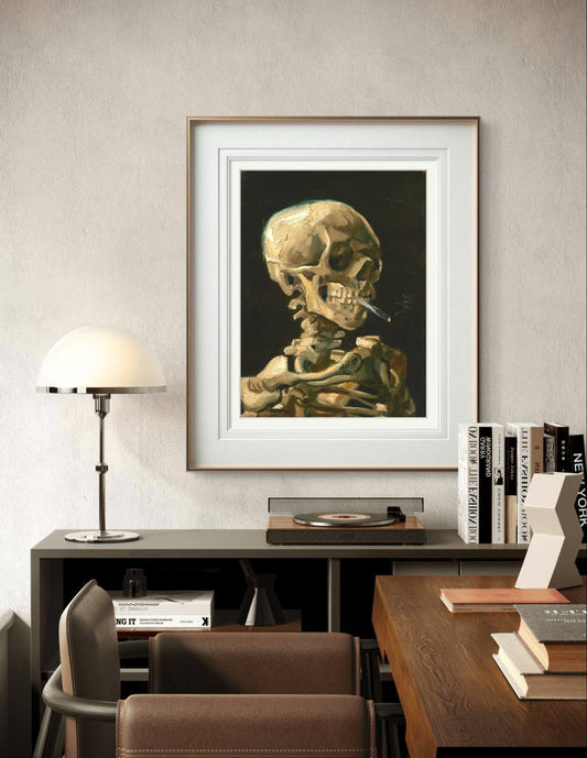 Displayed in a white frame, this dark and whimsical image of a smoking skeleton brings a unique, artistic edge to the space. The playful yet somber theme contrasts life and death, offering a bold conversation piece.