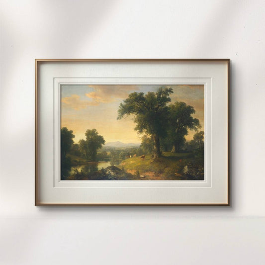 The framed artwork displays a peaceful countryside scene, with vibrant greenery and a golden sunset. The tranquil river and grazing cows create a calm atmosphere, bringing a sense of nature’s beauty to any space.