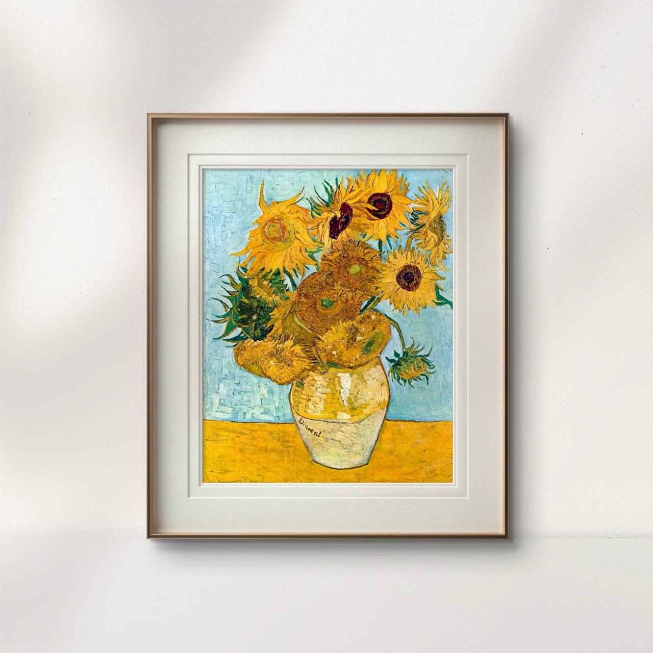 Displayed in a minimalist frame, Sunflowers by van Gogh brings a bright and energetic vibe to this room. The vibrant yellows and blues harmonize with the neutral decor, adding a timeless artistic flair to the space.