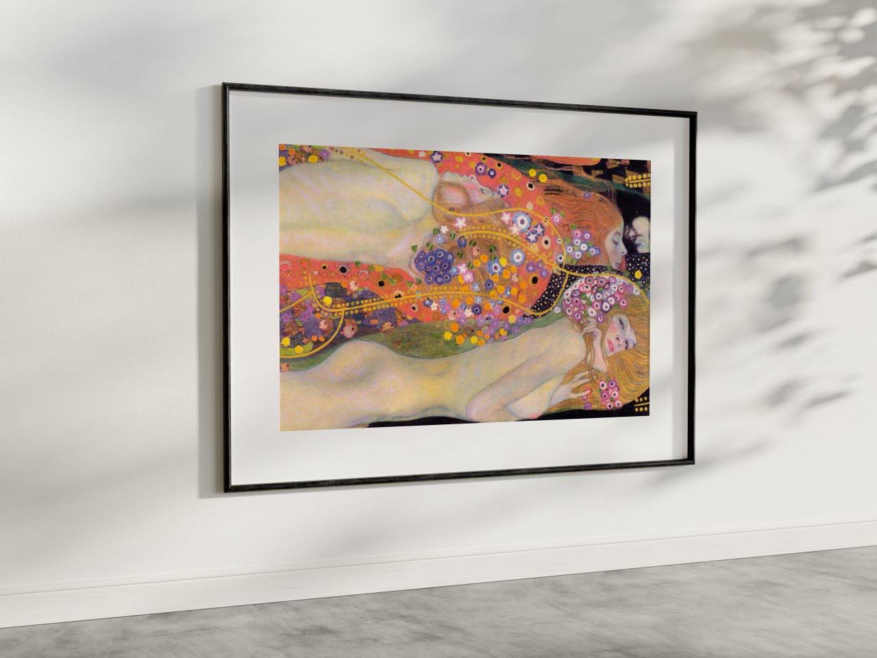 The framed artwork showcases Klimt's "Water Serpents II," with its ethereal figures and floral patterns. The soft, dreamlike forms and vibrant colors bring an elegant, artistic presence to the room.