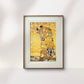  A framed painting of two figures in an embrace, surrounded by swirling golden patterns, hung on a light wall. The vivid gold and intricate details of the artwork add elegance to the minimalist decor of the room.