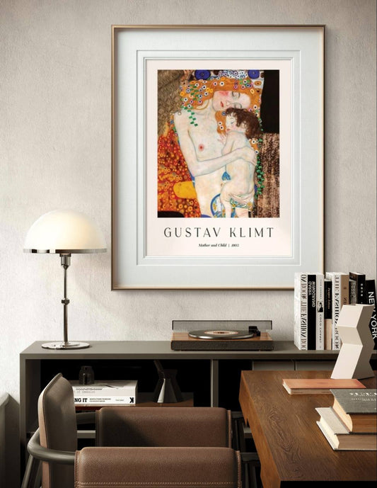 A framed exhibition poster featuring Klimt’s "Mother and Child." The tender embrace between the figures is showcased in a modern room with simple decor, emphasizing the artwork's emotional depth.