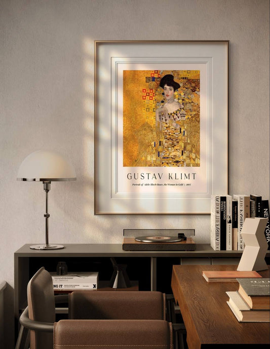 A framed portrait of "The Woman in Gold" by Gustav Klimt, placed in a modern room with neutral tones. The golden hues and complex patterns stand out, adding a sense of sophistication and timeless beauty to the decor.