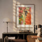  The framed painting from Image 2 is hung on a wall above a modern desk, accompanied by a lamp and books. Natural light filters into the room, creating a warm, cozy atmosphere around the artwork.
