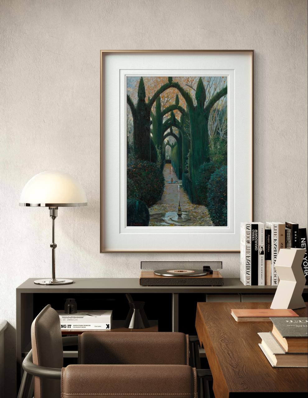 The framed artwork is displayed above a modern desk setup. A lamp and neatly arranged books surround the painting, while soft, natural light adds warmth to the room's peaceful ambiance.