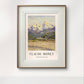  The framed painting, set in a simple wooden frame, depicts towering mountains with snowy peaks. The vibrant yet calming colors bring a serene, natural beauty to the room.