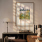 The framed painting of a serene riverside scene brings an air of nature into a modern room, with soft lighting enhancing the calming effect of the yellow and green plants near the water. The room feels both cozy and refined.