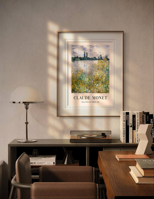 The framed painting of a serene riverside scene brings an air of nature into a modern room, with soft lighting enhancing the calming effect of the yellow and green plants near the water. The room feels both cozy and refined.