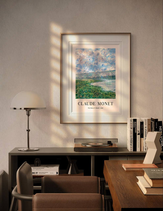 Displayed in a modern, warmly lit room, Monet's painting brings a peaceful atmosphere to the space. The textured clouds and soft river hues add depth and tranquility to the setting.