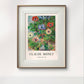 The same Claude Monet painting, elegantly framed and displayed on a white wall, showcasing bright anemone flowers in a minimalistic setting.