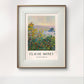 The framed Monet poster "Flower Beds at Vétheuil," displaying vivid flowers with a river in the background, hangs on a minimalist white wall, providing a clean and elegant look.