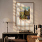 This framed Monet poster, "Roses in the Hoshede's Garden," hangs in a cozy room above a desk, illuminated by soft, natural sunlight, creating a peaceful, artistic atmosphere.