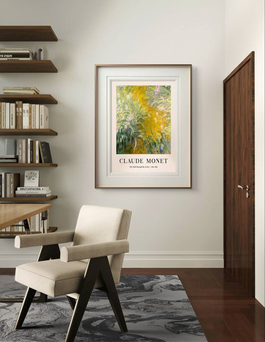  This Monet poster, "The Path through the Irises," is framed and hanging in a peaceful, modern room above a chair and bookshelf. The room is softly lit, highlighting the natural beauty of the artwork.