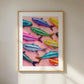Framed artwork of colorful fish on a pink background