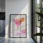 Framed artwork of a colorful cocktail in a kitchen with natural light