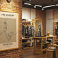 Fashion store interior with framed artwork on brick wall
