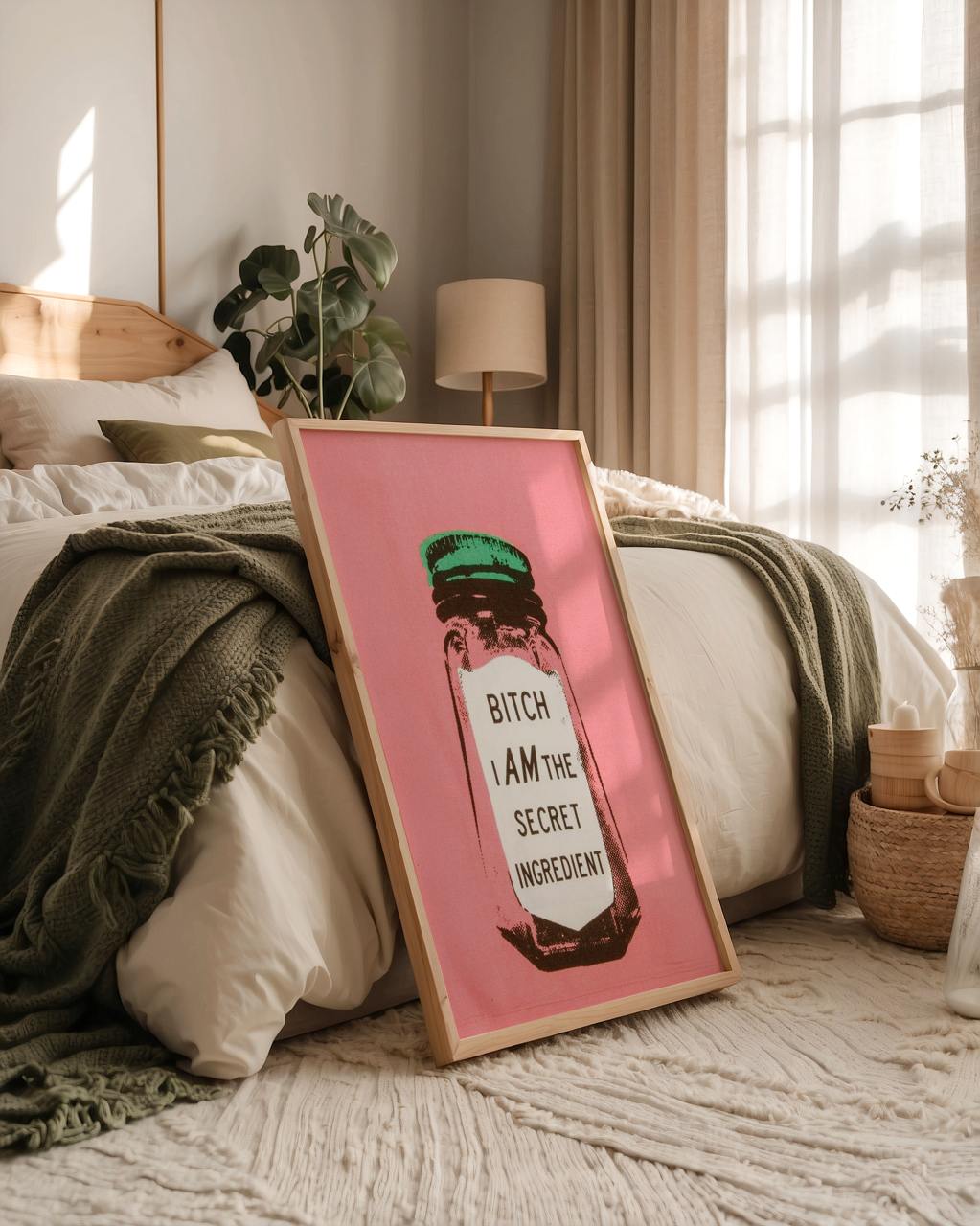 Framed artwork with text on a bed in a bedroom setting