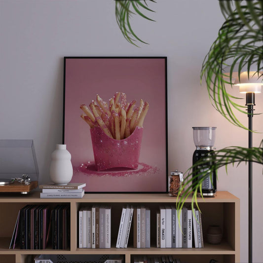 Framed artwork of pink fries on a bookshelf with decor items.