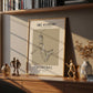 Framed artwork on a shelf with decorative items
