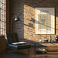 Modern living room with a brick wall, sofa, coffee table, and framed basketball poster.