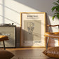 Living room with a framed poster of a basketball design, Marshall amplifier, and brown chair.