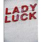 A white textured background featuring the words "Lady Luck" in three-dimensional red letters, connected by thin gold wires, creating a vintage and elegant visual effect.