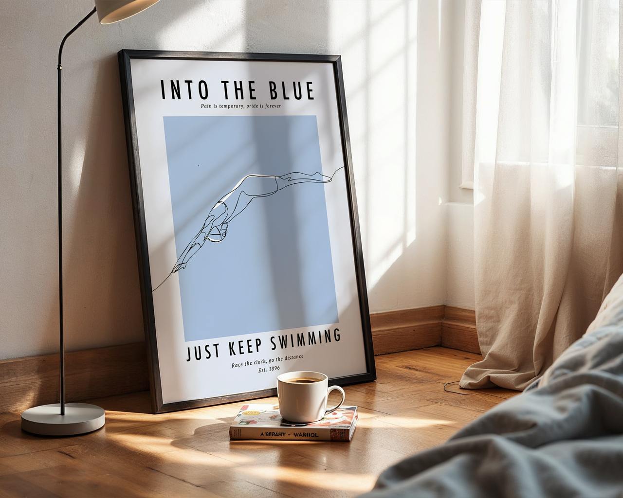 Framed poster with 'Into the Blue' and 'Just Keep Swimming' text in a room with a lamp and cup.
