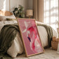Framed artwork of a pink flamingo in a bedroom setting