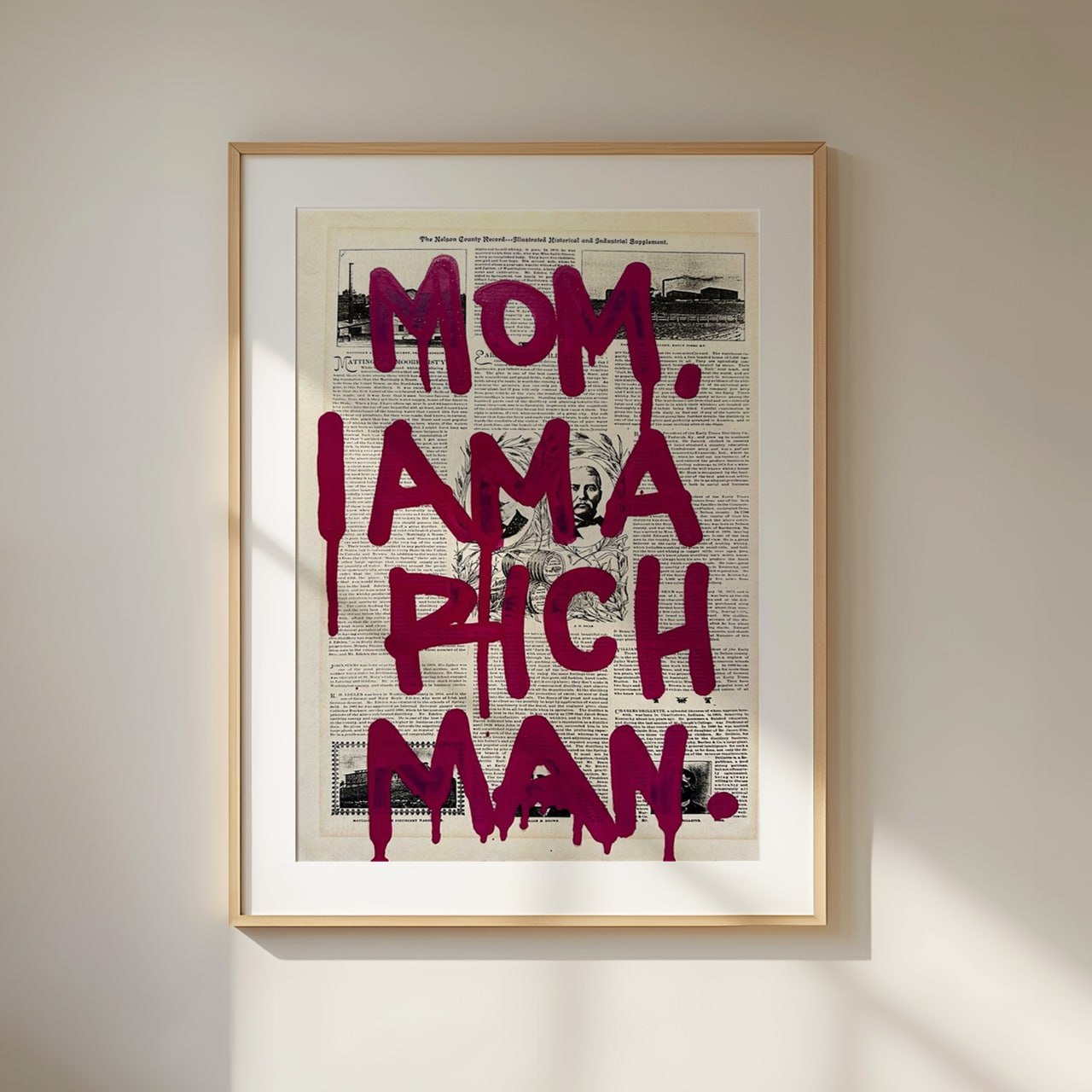 A vintage newspaper print with a black-and-white background, featuring a bold graffiti-style quote in dark burgundy letters reading “Mom, I Am a Rich Man.” The text appears to be dripping, mimicking spray paint, giving it an edgy street-art feel. The background contains old newspaper articles and a subtle portrait in the center, adding a vintage and artistic contrast to the modern graffiti typography.