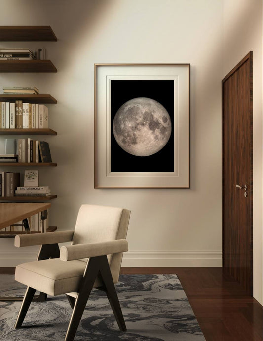 This framed full moon print brings a sense of calm and wonder to a cozy reading nook. The warm tones of the room’s decor contrast beautifully with the stark black background of the moon poster, creating a harmonious balance between modern design and natural elements. This Full Moon Art-Print is perfect for those seeking to add a piece of the universe to their home while maintaining a refined and stylish ambiance. Ideal for a variety of spaces, from a hallway to a home office, this Poster makes for an excell