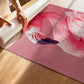 Person unrolling a pink flamingo poster on a wooden floor