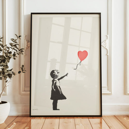 This artwork features a silhouette of a young girl in a dress, standing with her back to the viewer. She reaches out with her right hand towards a bright red heart-shaped balloon that floats away above her. The background is simple and white, allowing the girl and the balloon to stand out prominently