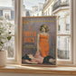 The image presents a framed cover of a vintage pulp fiction book titled “I Prefer Girls” by Jessie Dumont, prominently displayed on a windowsill in a chic Parisian apartment.