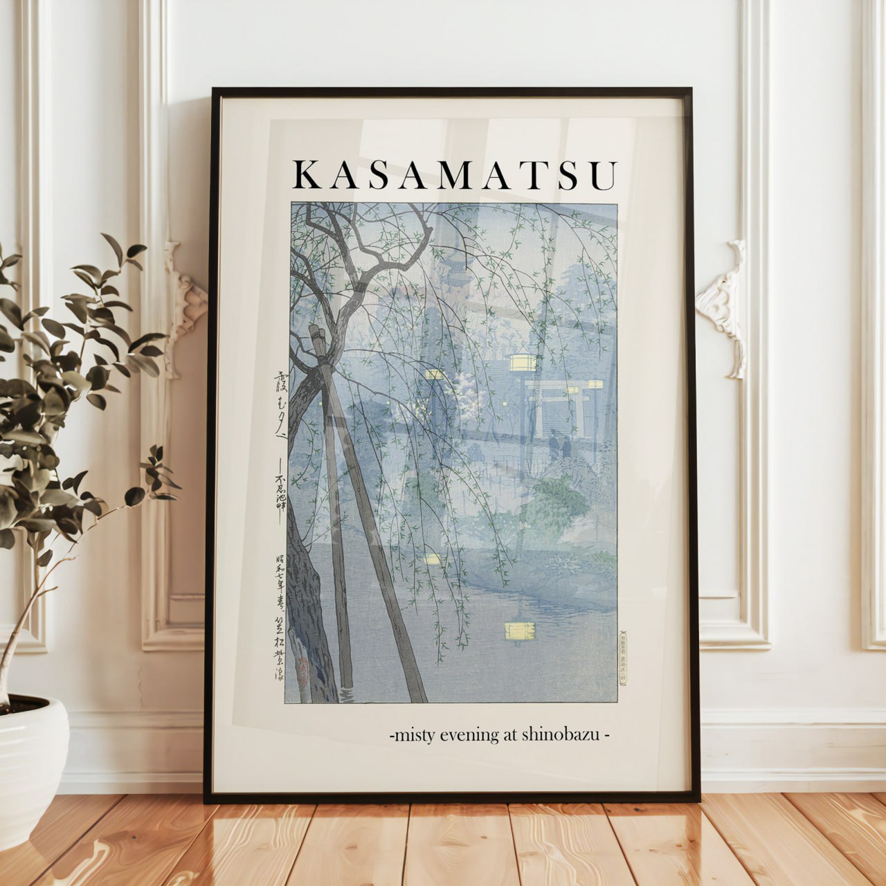 A serene Japanese poster titled "Kasamatsu." It depicts a misty evening scene with bare tree branches against a soft blue-gray background. Dim yellow lights from distant buildings glow through the fog, creating a peaceful, dreamlike atmosphere. The title below reads, "misty evening at shinobazu.