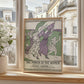 This image features a framed vintage poster titled “The March of the Women,” leaning against a wooden windowsill. The poster is displayed in a well-lit modern apartment