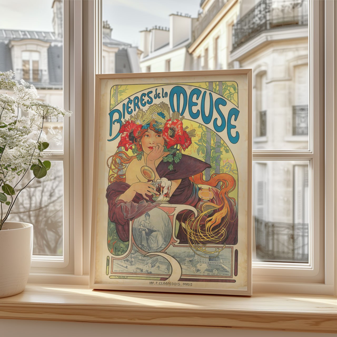 The image shows a framed vintage poster for Bières de la Meuse, placed on a wooden windowsill